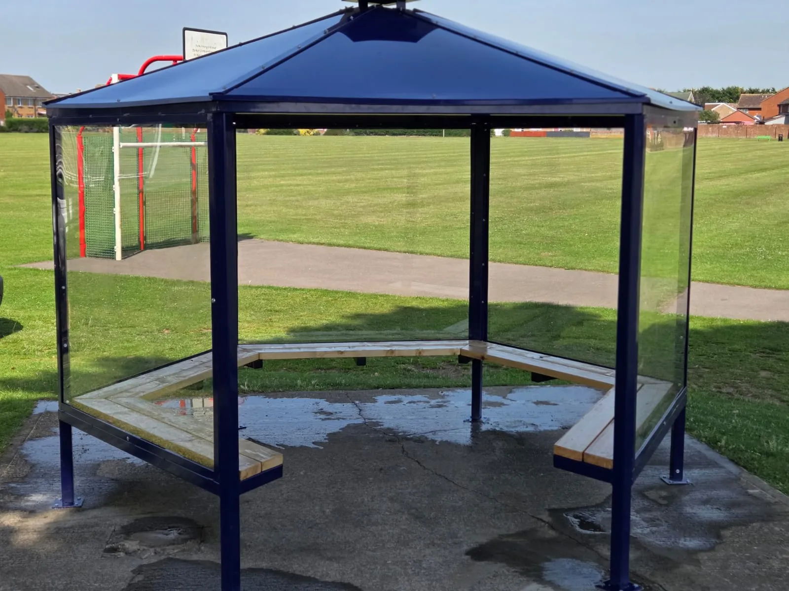 Steel and glass entrance canopy over a rear service door